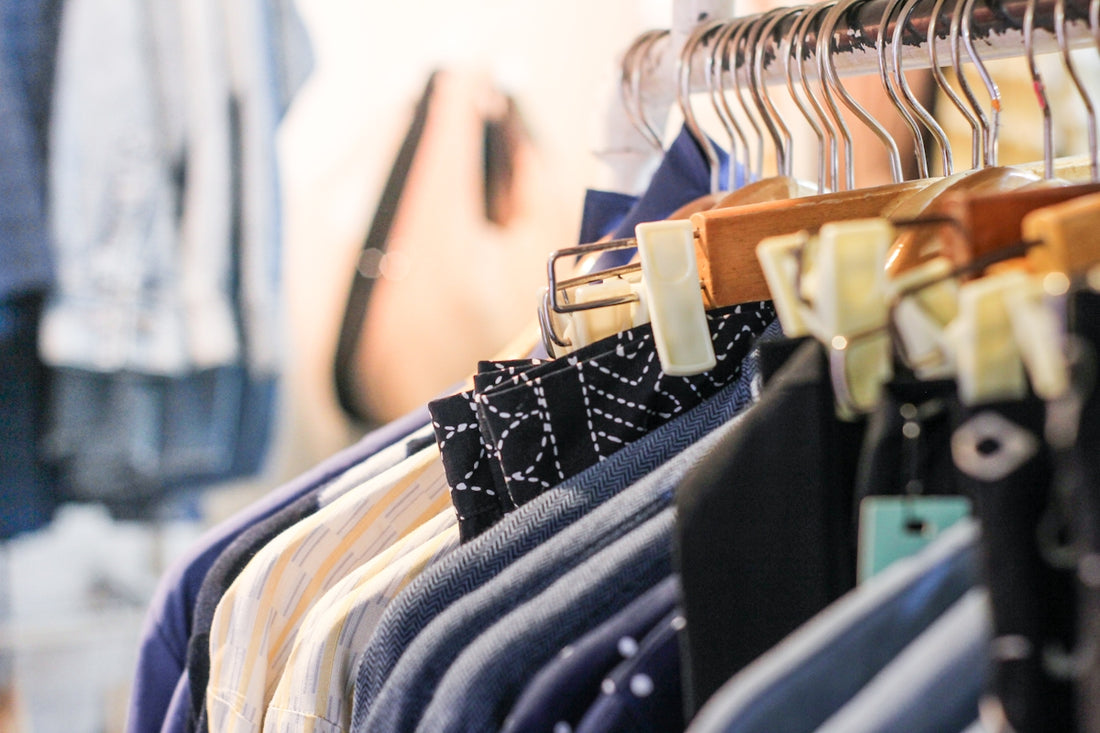 a rack of clothes hanging on a clothes rack