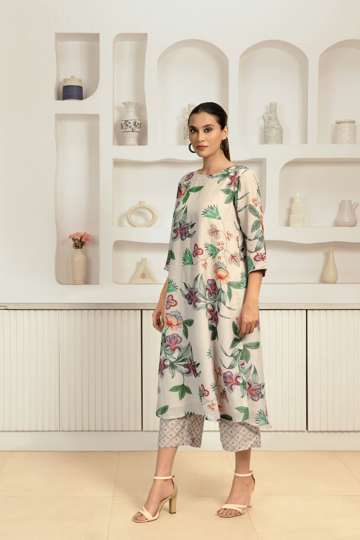 A woman standing in front of a display of vases