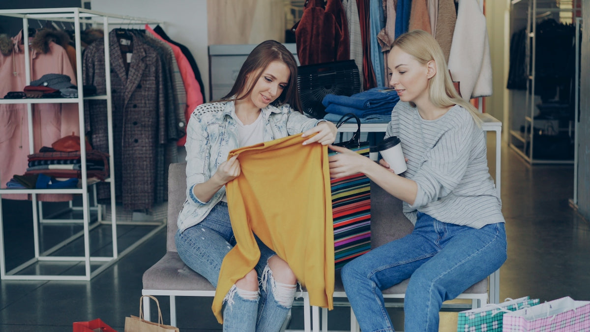 Two women are shopping for clothes together