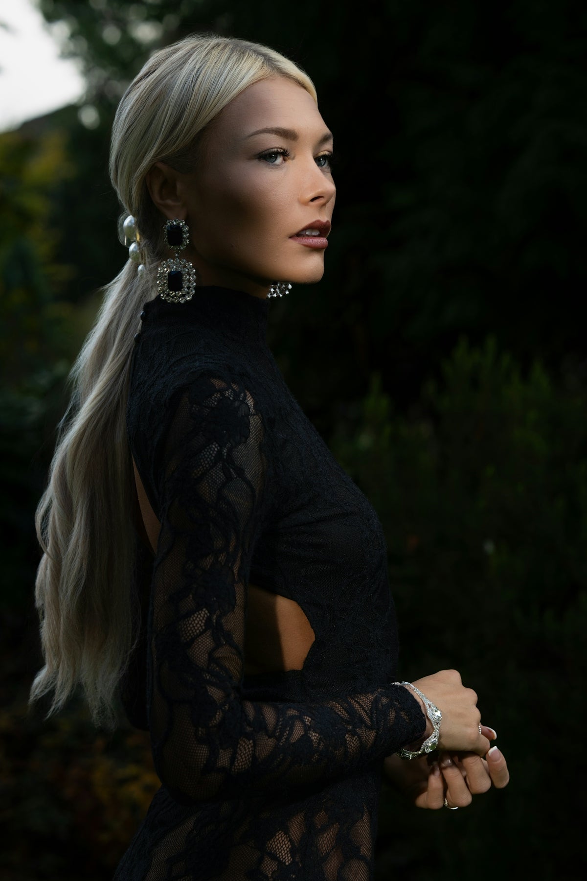 Elegant woman in black lace dress outdoors