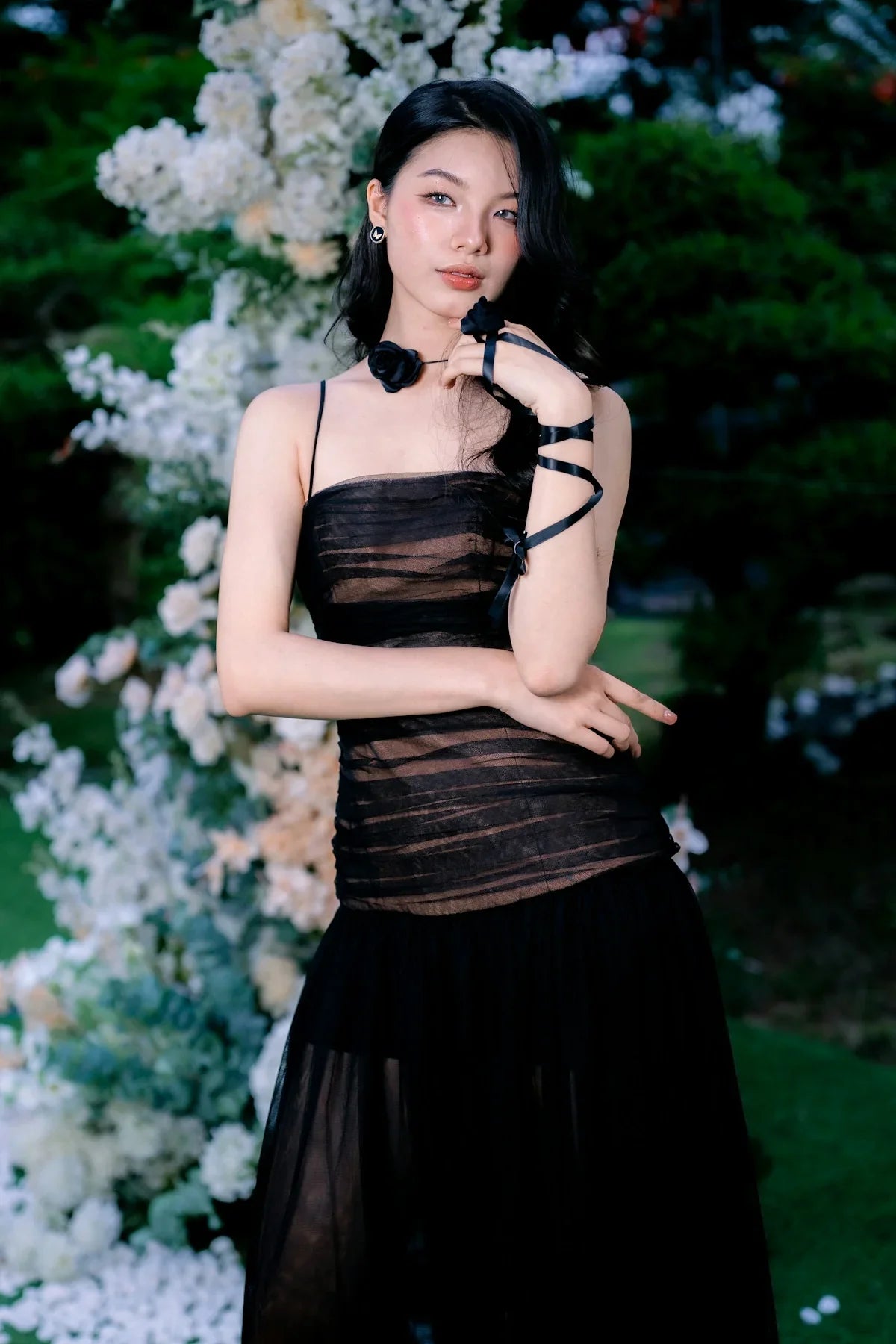 Elegant woman in a black dress with floral decorations