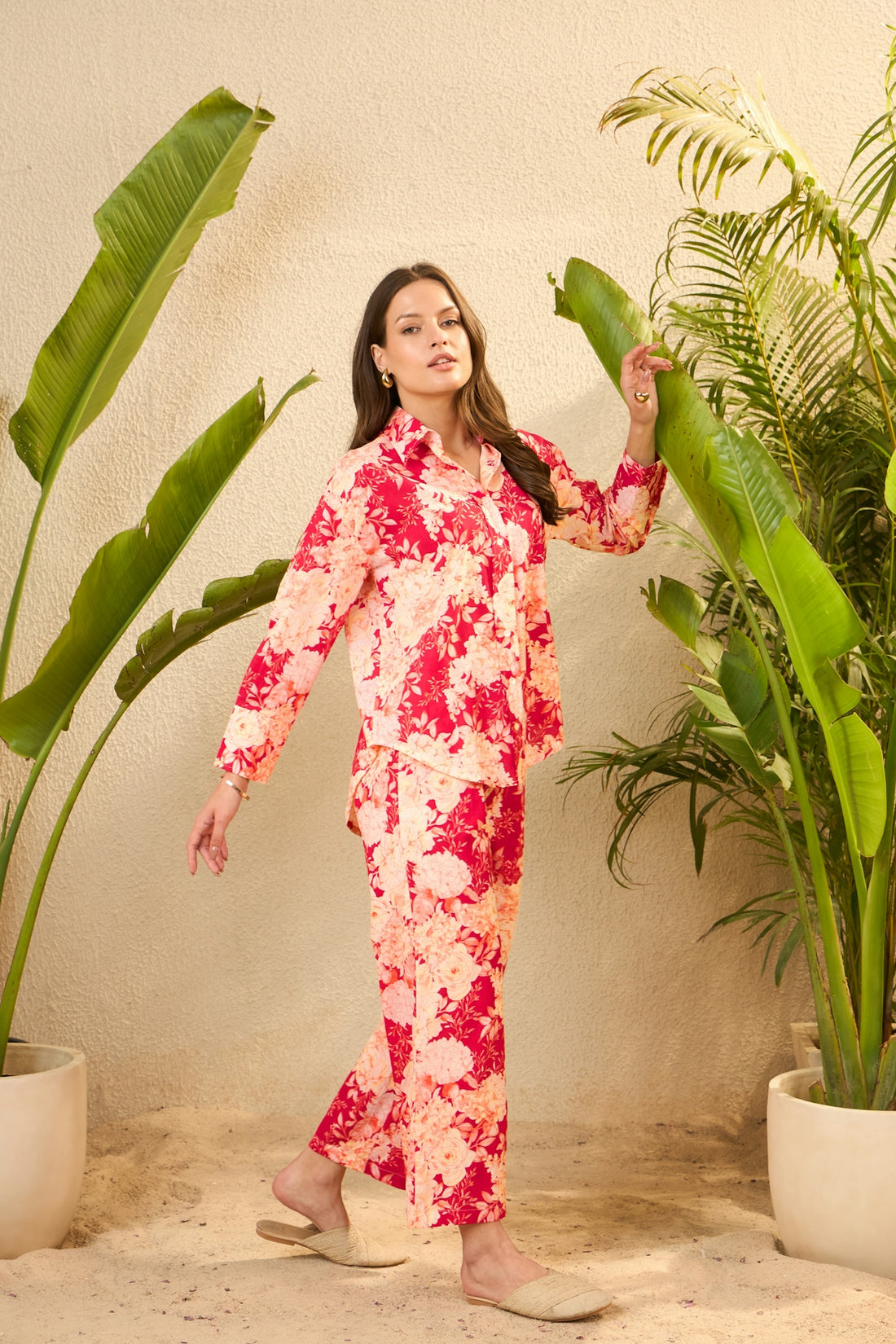 Woman in a pink and red tie-dye pajama set.